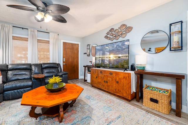 living room with ceiling fan and light wood-type flooring