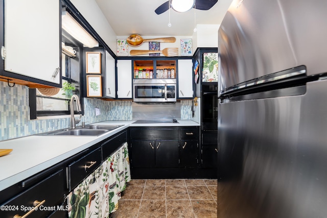 kitchen featuring ceiling fan, sink, stainless steel appliances, backsplash, and white cabinets