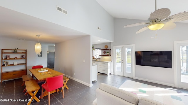 dining space featuring high vaulted ceiling and ceiling fan