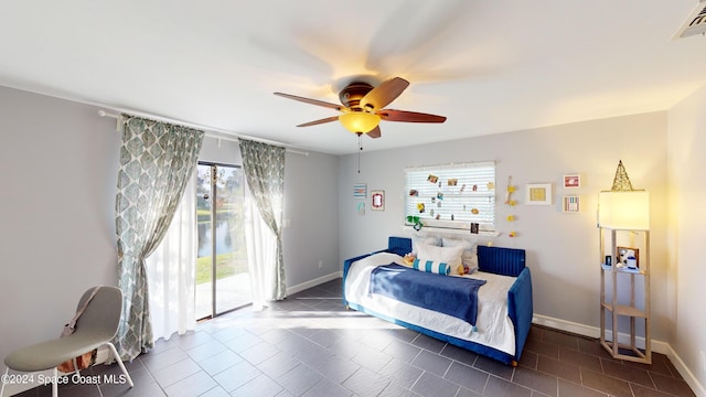 bedroom with dark tile patterned flooring, ceiling fan, access to outside, and multiple windows