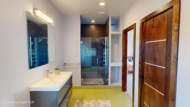 bathroom featuring vanity, an enclosed shower, and tile patterned flooring