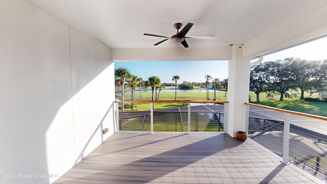 exterior space with a yard, a water view, and ceiling fan