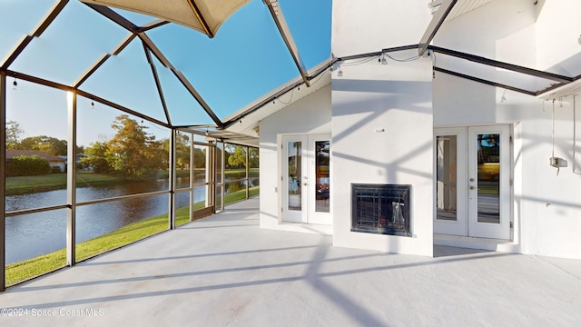 unfurnished sunroom featuring french doors and a water view