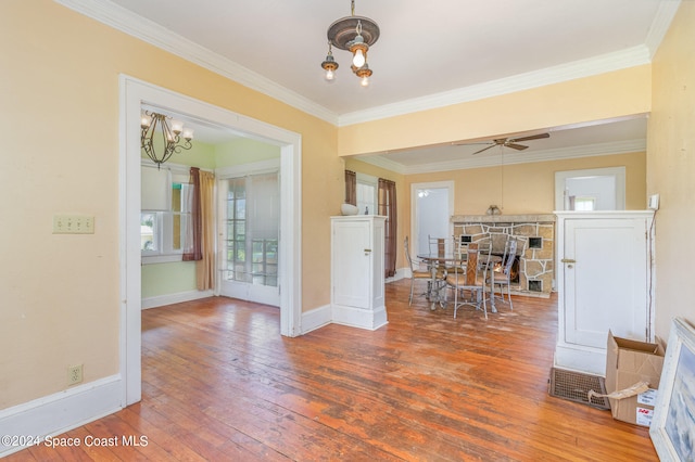 dining area featuring crown molding, ceiling fan with notable chandelier, and hardwood / wood-style floors