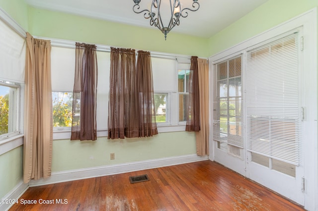 interior space featuring a healthy amount of sunlight and a chandelier