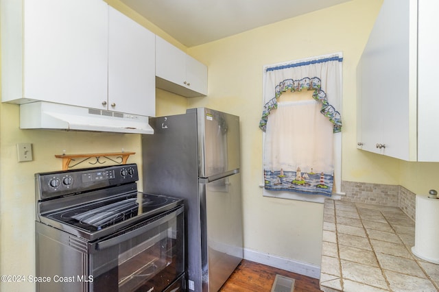 kitchen with black range with electric cooktop, white cabinets, light hardwood / wood-style floors, and stainless steel refrigerator