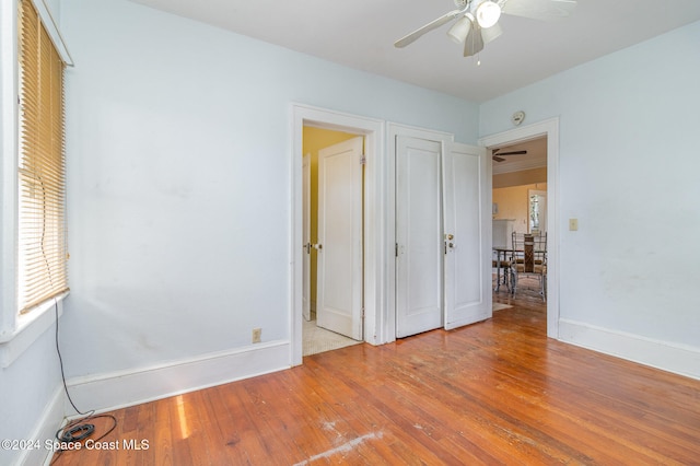 unfurnished bedroom with ceiling fan and light hardwood / wood-style flooring