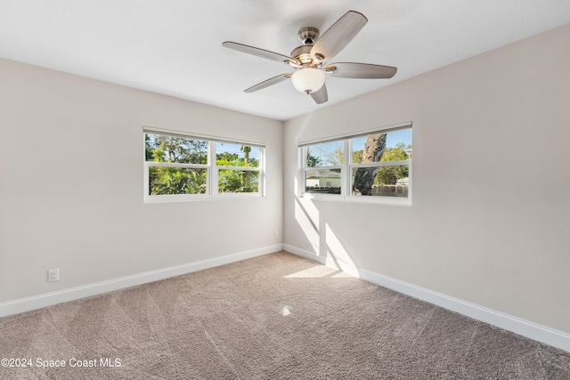 unfurnished room with ceiling fan and carpet floors