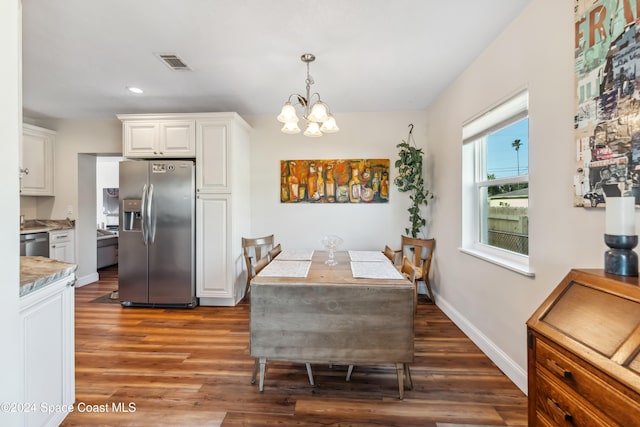 dining room featuring a notable chandelier and dark hardwood / wood-style floors