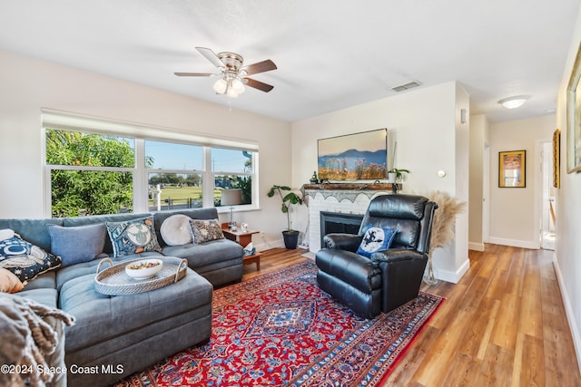 living room with light hardwood / wood-style floors and ceiling fan