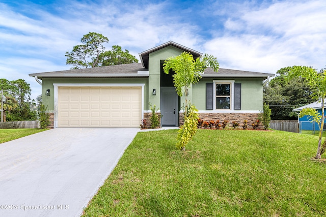 view of front facade with a front yard and a garage