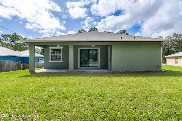 rear view of house featuring a patio, ceiling fan, and a lawn