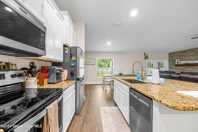 kitchen featuring white cabinetry, light hardwood / wood-style floors, stainless steel appliances, and sink