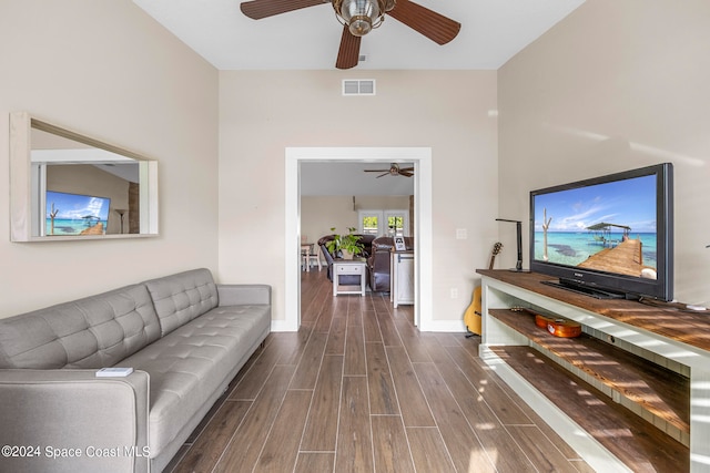 living room with dark hardwood / wood-style floors and ceiling fan