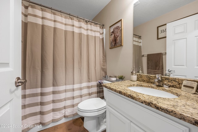 bathroom featuring vanity, a textured ceiling, toilet, and a shower with shower curtain