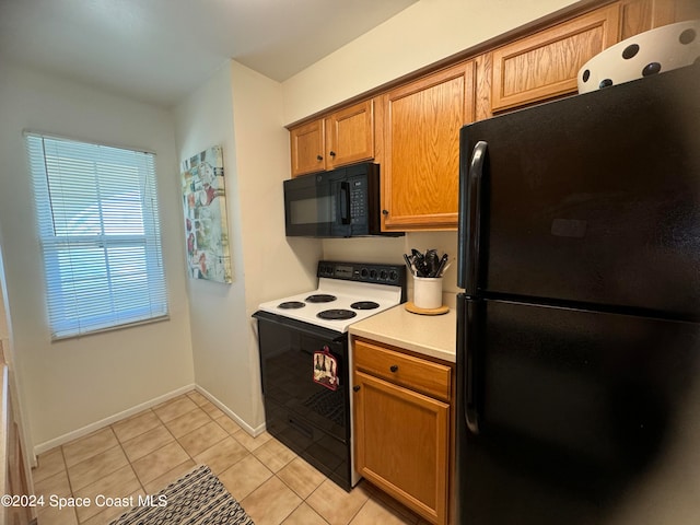 kitchen with black appliances and light tile patterned floors