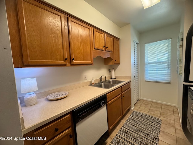 kitchen with sink, light tile patterned floors, and dishwasher