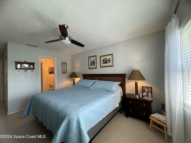 carpeted bedroom featuring a textured ceiling and ceiling fan