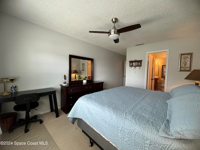 bedroom with ensuite bathroom, carpet flooring, a textured ceiling, and ceiling fan