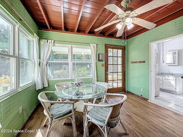 sunroom / solarium with ceiling fan, wooden ceiling, and plenty of natural light