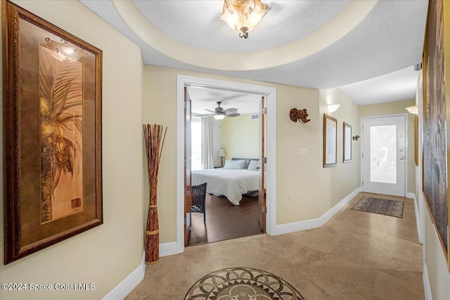 hallway featuring a raised ceiling