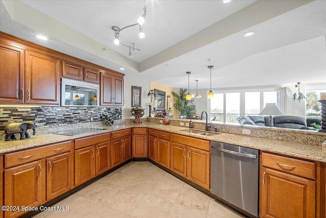 kitchen featuring decorative backsplash, light stone counters, stainless steel appliances, sink, and pendant lighting