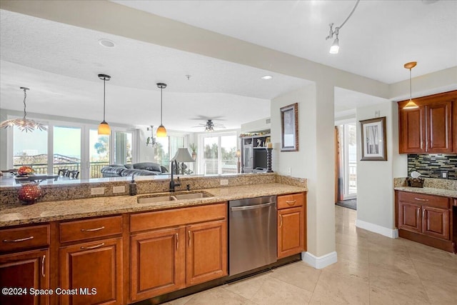 kitchen with dishwasher, sink, ceiling fan, decorative light fixtures, and light stone counters