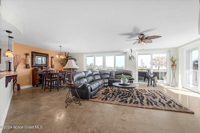 living room with a textured ceiling and ceiling fan