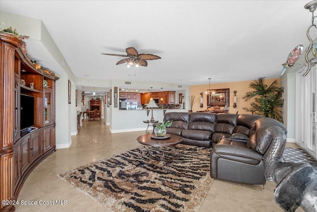 living room featuring ceiling fan with notable chandelier