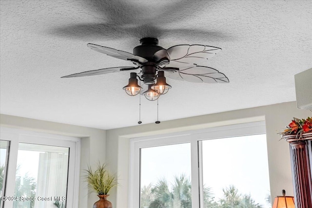 interior details featuring ceiling fan and a textured ceiling