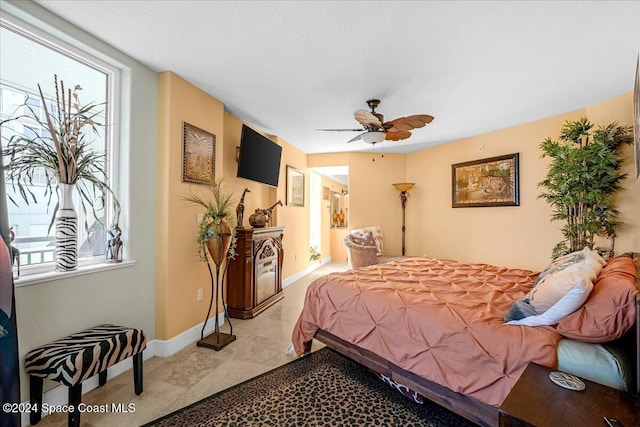 bedroom with ceiling fan and connected bathroom