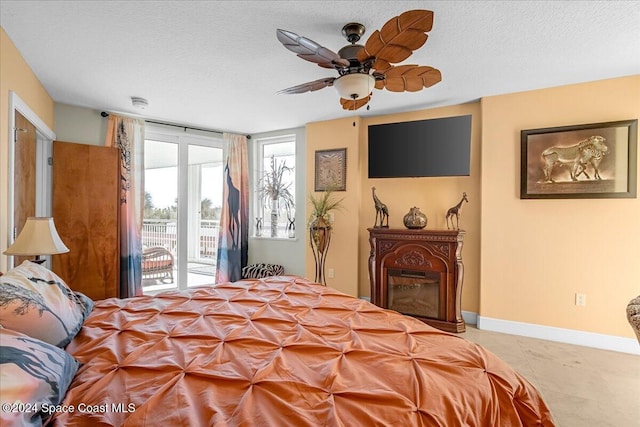 bedroom featuring access to exterior, a textured ceiling, ceiling fan, and light tile patterned flooring