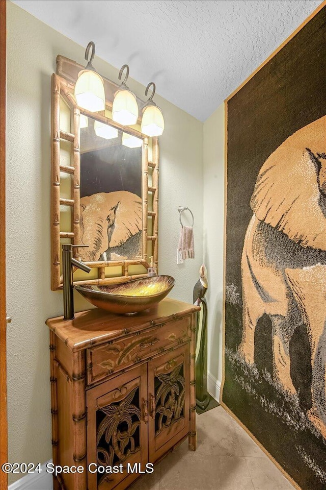 bathroom featuring vanity and a textured ceiling