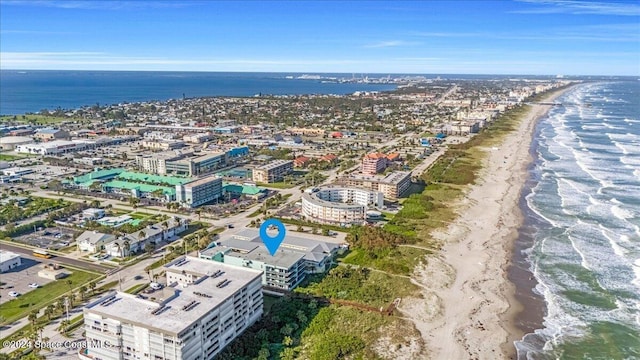 bird's eye view with a water view and a beach view