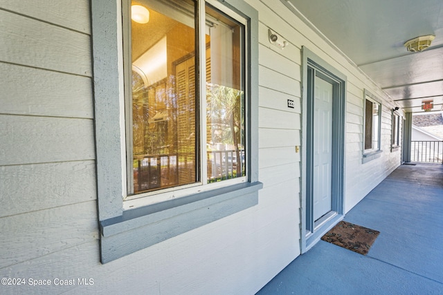 view of exterior entry with covered porch