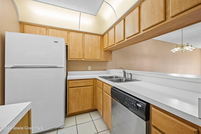 kitchen featuring sink, a notable chandelier, light tile patterned floors, stainless steel dishwasher, and white fridge