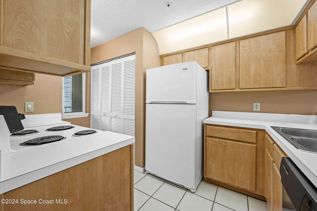 kitchen featuring white appliances, light tile patterned flooring, sink, a textured ceiling, and ventilation hood