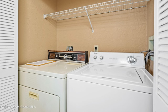 clothes washing area featuring washing machine and clothes dryer