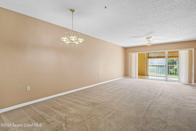 carpeted spare room featuring a textured ceiling and ceiling fan with notable chandelier