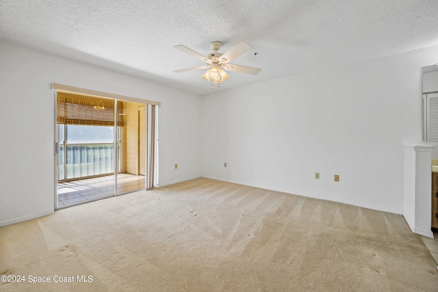 unfurnished living room with a textured ceiling, light colored carpet, and ceiling fan