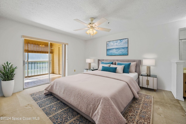 carpeted bedroom featuring a textured ceiling, access to exterior, and ceiling fan