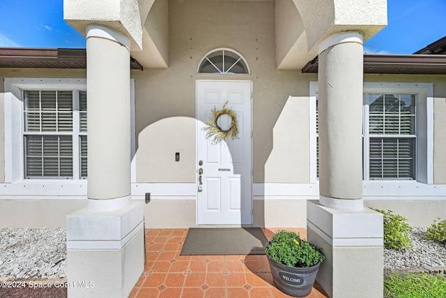 view of exterior entry with a porch