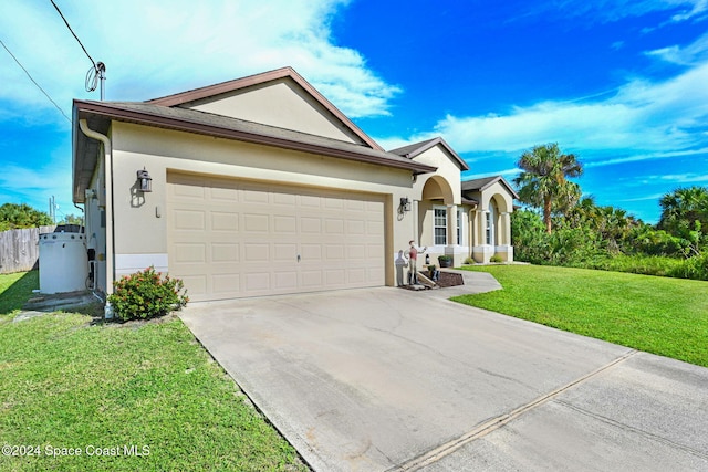 single story home featuring a front yard and a garage