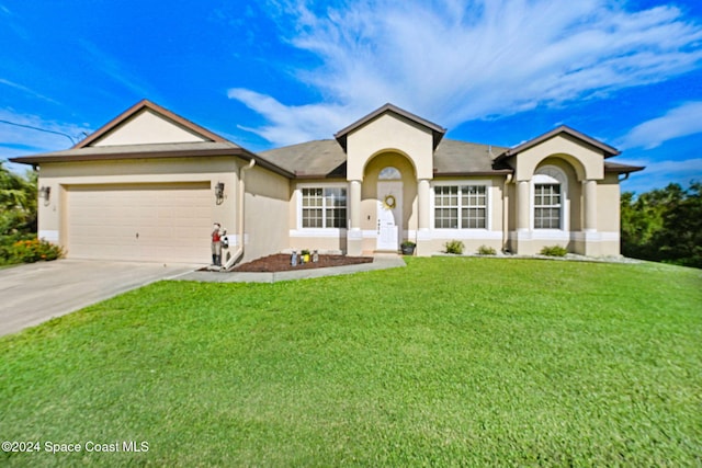 view of front of property featuring a garage and a front yard