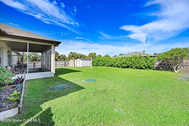 view of yard featuring a shed and a sunroom