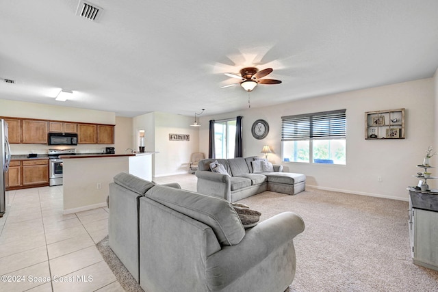 tiled living room with ceiling fan