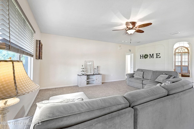 living room featuring carpet and ceiling fan