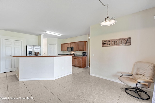 kitchen featuring light tile patterned floors, a kitchen island, and stainless steel fridge with ice dispenser