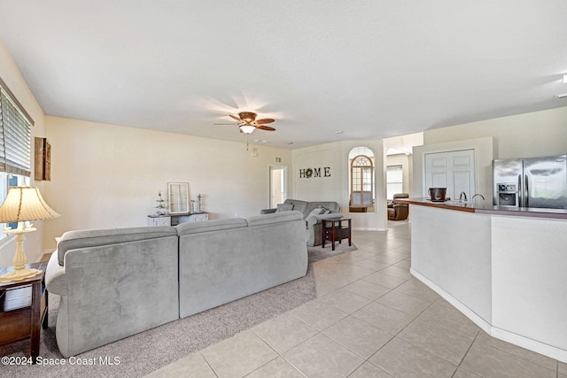 living room featuring light tile patterned floors and ceiling fan