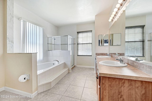 bathroom featuring vanity, plus walk in shower, a wealth of natural light, and tile patterned floors